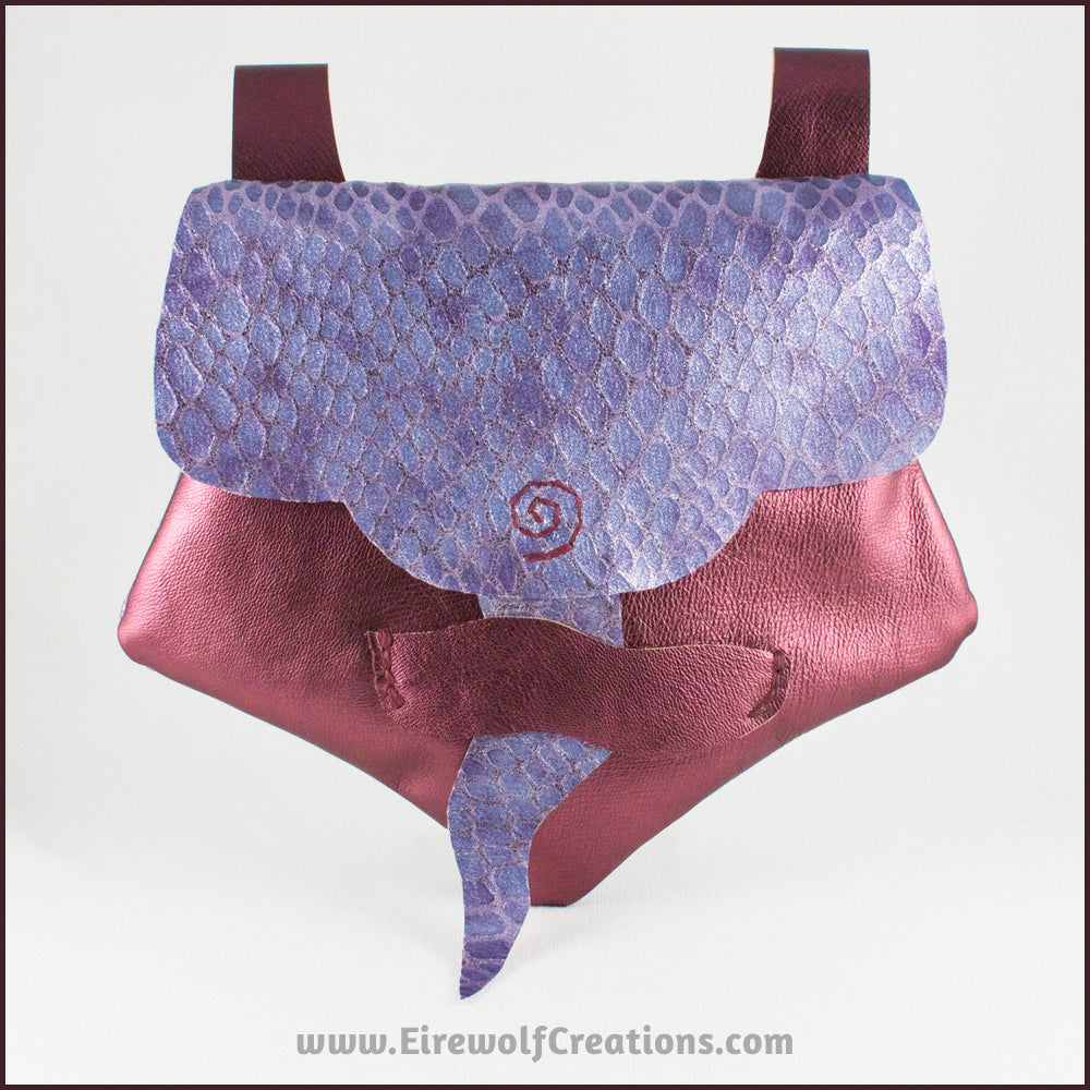 Handmade leather belt pouches in a medieval style with a scaled dragon skin texture, in purple or silver colors. By Erin Metcalf of Eirewolf Creations.