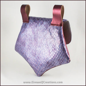 Handmade leather belt pouches in a medieval style with a scaled dragon skin texture, in purple or silver colors. Back view. By Erin Metcalf of Eirewolf Creations.