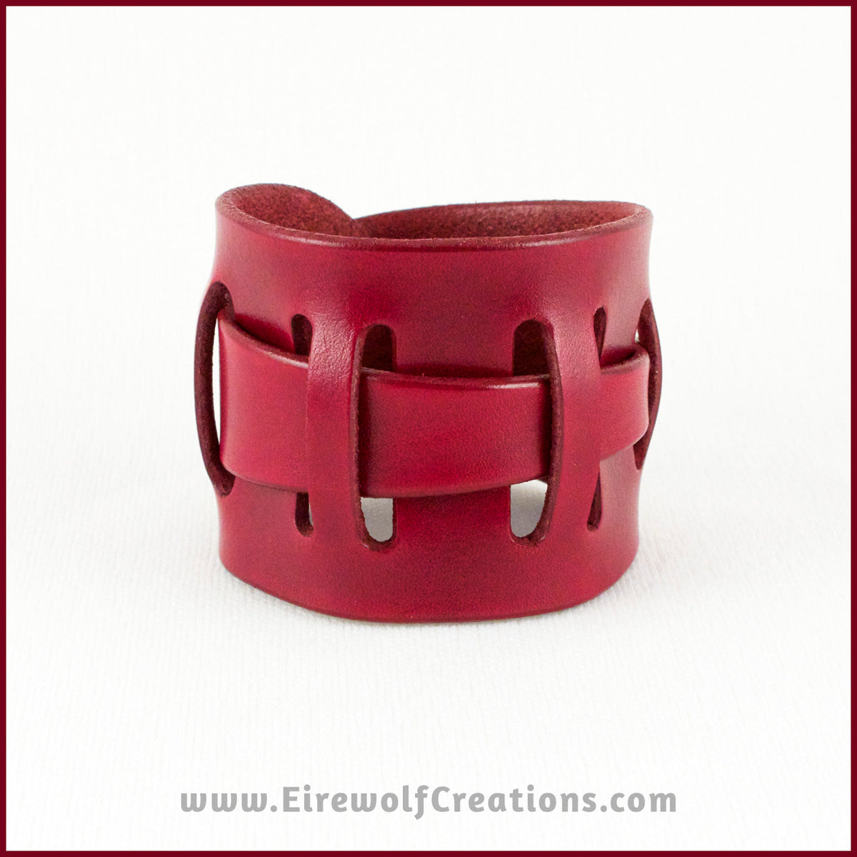 Handmade Leather Adjustable Claspless Slotted Wrist Cuff Bracelet, 2 inches wide, dyed red. By Erin Metcalf of Eirewolf Creations.