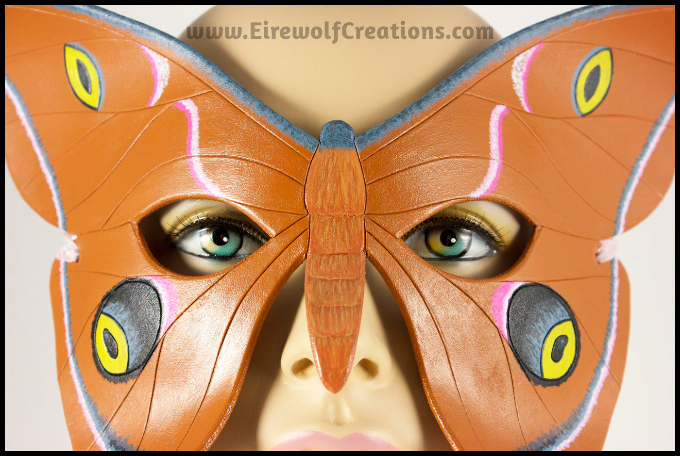 Closeup of a handmade leather moth mask for a masquerade costume, handpainted to resemble the Antheraea Polyphemus moth. By Erin Metcalf of Eirewolf Creations.