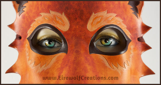 Detail of a handmade leather Wolf masquerade mask in rich tawny brown colors, with carved and painted fur details. By Erin Metcalf of Eirewolf Creations.