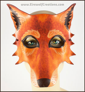 A handmade leather Wolf masquerade mask in rich tawny brown colors, with carved and painted fur details. By Erin Metcalf of Eirewolf Creations.